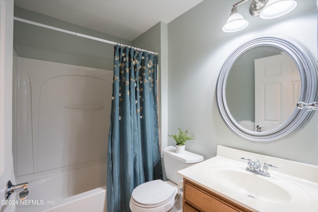 full bathroom with shower / bath combo, vanity, and toilet