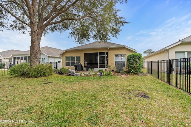 rear view of property with a lawn