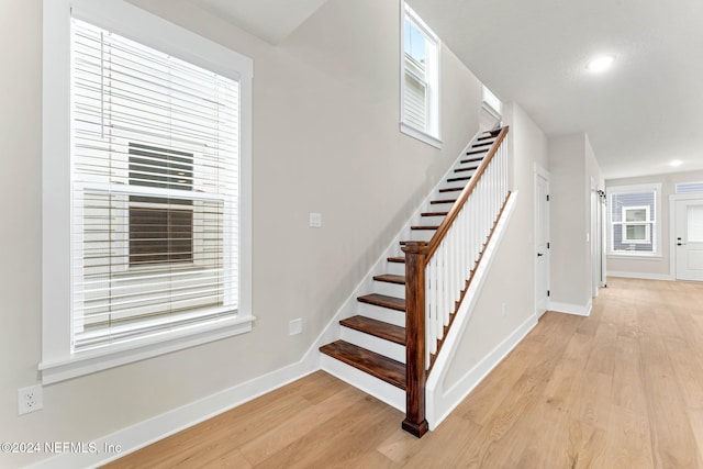 stairway with hardwood / wood-style flooring