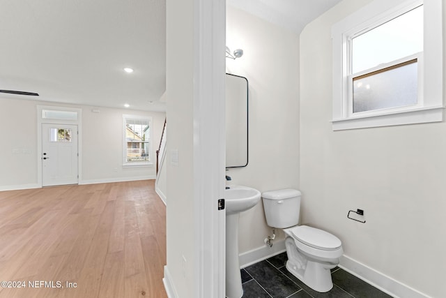 bathroom with sink, hardwood / wood-style floors, and toilet
