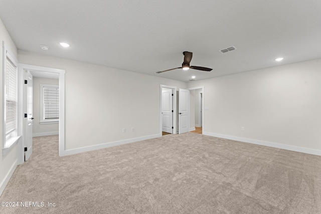 unfurnished bedroom featuring light colored carpet and ceiling fan