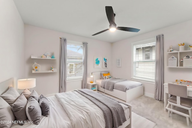 bedroom featuring light colored carpet and ceiling fan