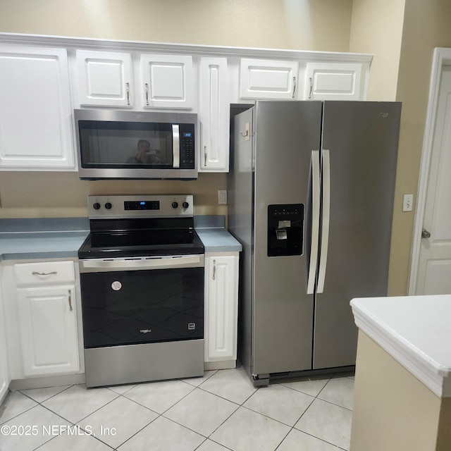 kitchen with white cabinetry, light tile patterned floors, and appliances with stainless steel finishes