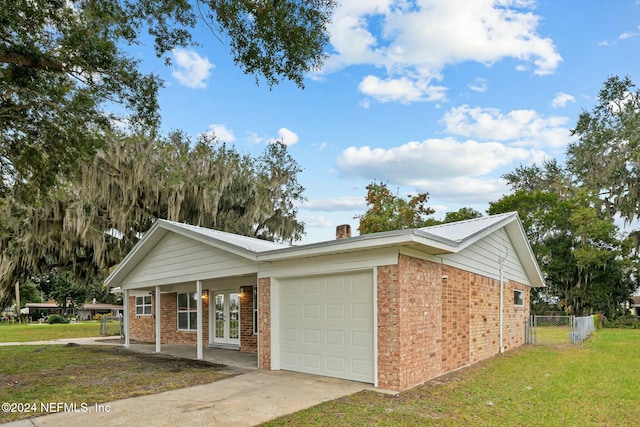 view of front of home with french doors and a front lawn