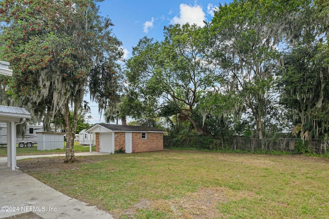 view of yard with a garage and an outdoor structure