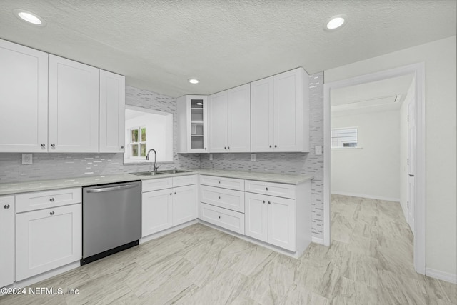 kitchen featuring white cabinets, tasteful backsplash, a textured ceiling, sink, and dishwasher