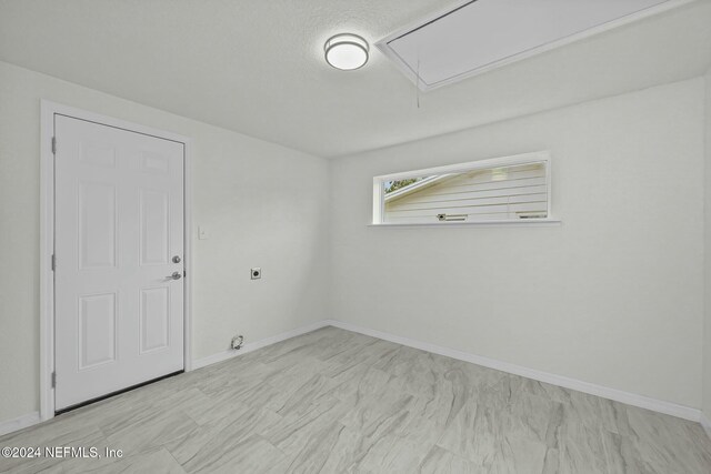 unfurnished room featuring a textured ceiling