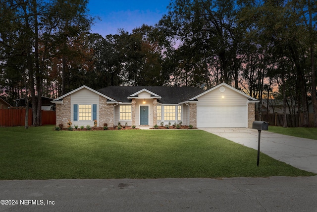 ranch-style house with a lawn and a garage