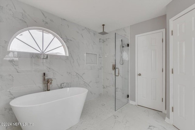 bathroom with separate shower and tub and tile walls