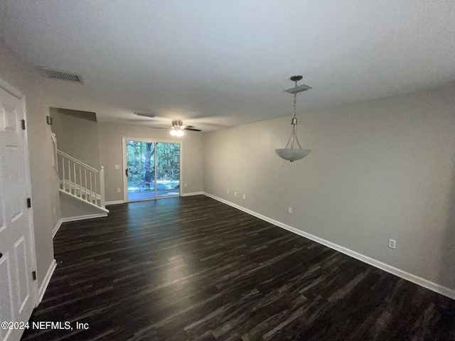 unfurnished living room with dark hardwood / wood-style floors and ceiling fan