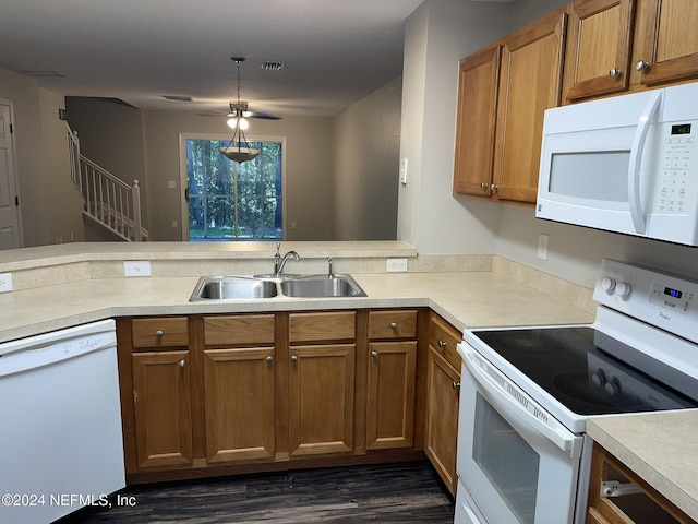 kitchen with ceiling fan, sink, dark hardwood / wood-style flooring, pendant lighting, and white appliances