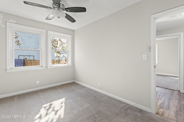 unfurnished room with a textured ceiling, hardwood / wood-style flooring, and ceiling fan