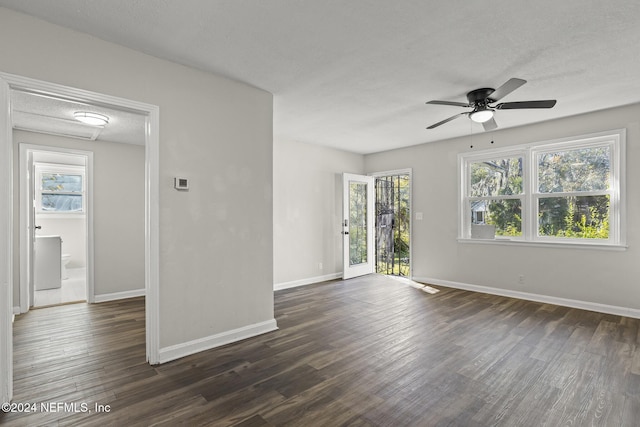 unfurnished room with ceiling fan, dark hardwood / wood-style flooring, and a textured ceiling