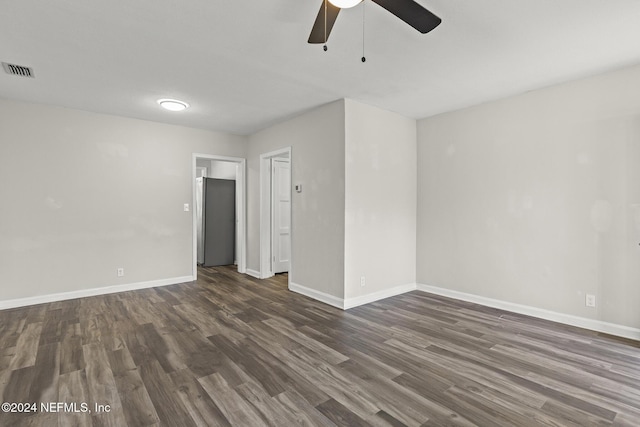 unfurnished room with ceiling fan and dark wood-type flooring