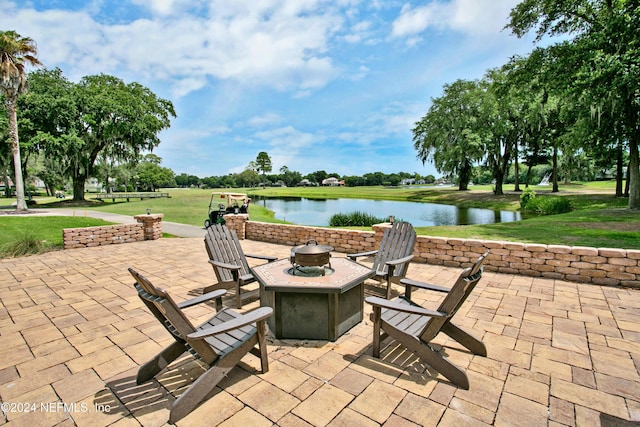 view of patio featuring a water view and a fire pit