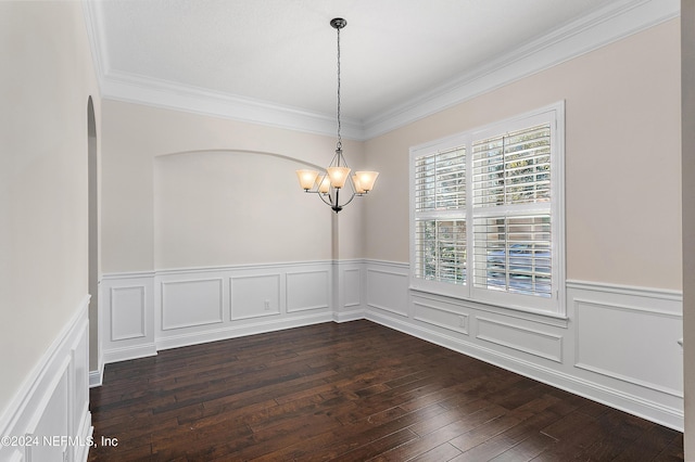 empty room with crown molding, dark hardwood / wood-style floors, and a notable chandelier