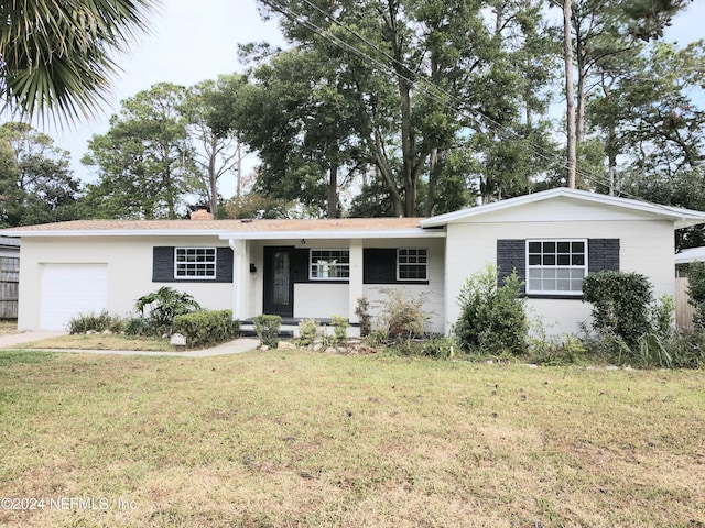 ranch-style house with a garage and a front lawn