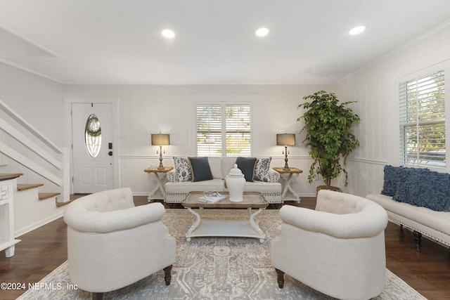 living room with hardwood / wood-style floors and crown molding