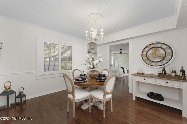 dining space featuring crown molding, ceiling fan with notable chandelier, dark wood-type flooring, and a textured ceiling