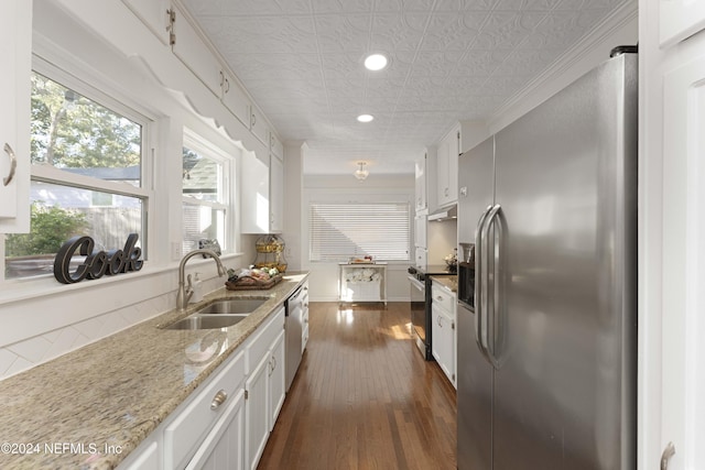 kitchen with white cabinetry, sink, stainless steel appliances, and dark hardwood / wood-style floors