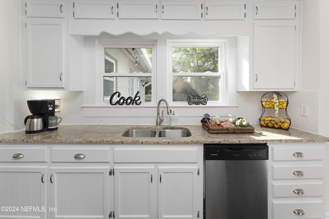 kitchen with white cabinets, dishwasher, sink, and tasteful backsplash