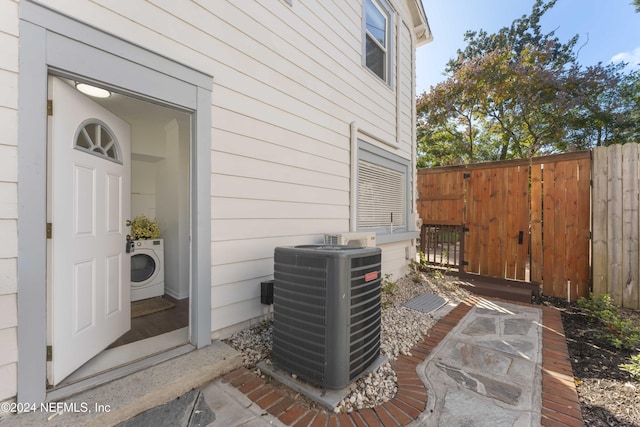 exterior space with washer / clothes dryer and central AC