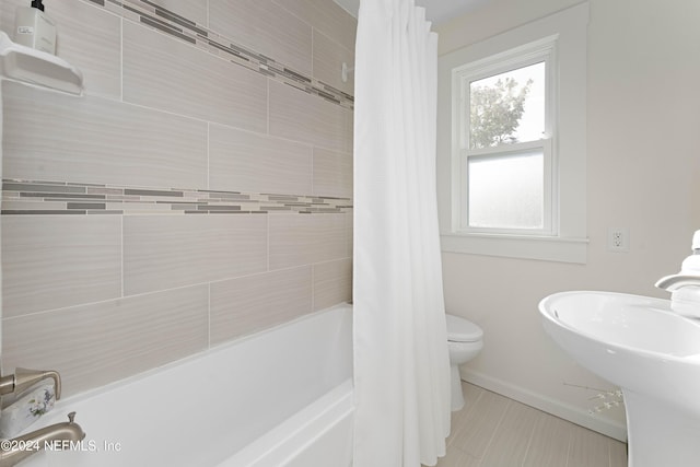 full bathroom featuring toilet, sink, and shower / tub combo