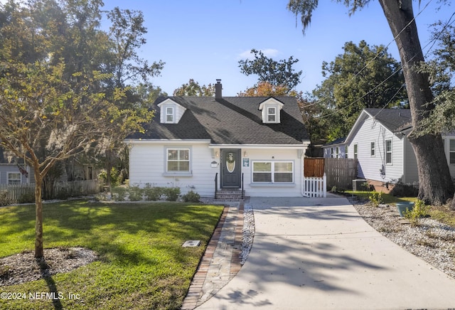 cape cod home with a front lawn