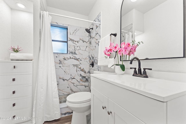 bathroom featuring hardwood / wood-style floors, vanity, toilet, and walk in shower