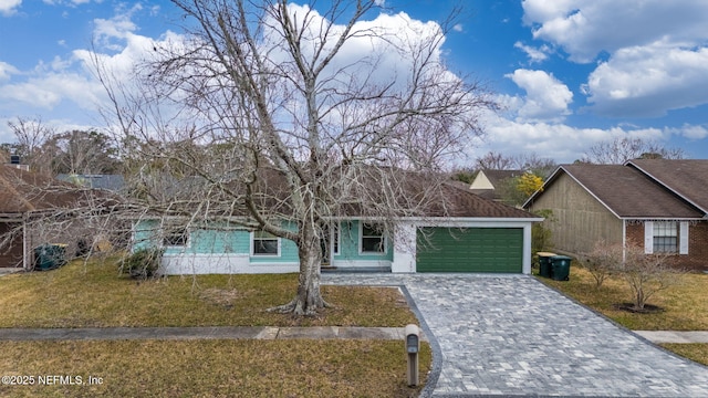 view of front of property featuring a garage and a front yard