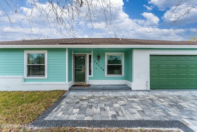 single story home featuring a garage