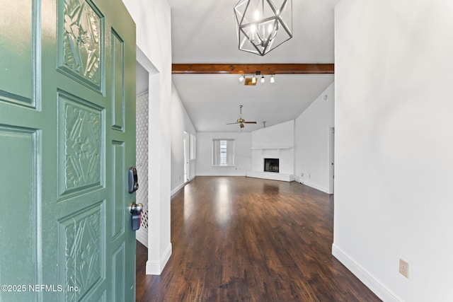 foyer entrance featuring ceiling fan with notable chandelier, dark hardwood / wood-style flooring, and lofted ceiling with beams