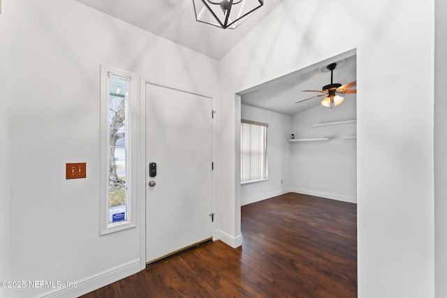 foyer entrance featuring ceiling fan, vaulted ceiling, dark hardwood / wood-style flooring, and a healthy amount of sunlight