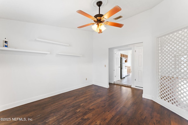 spare room featuring ceiling fan and dark hardwood / wood-style floors