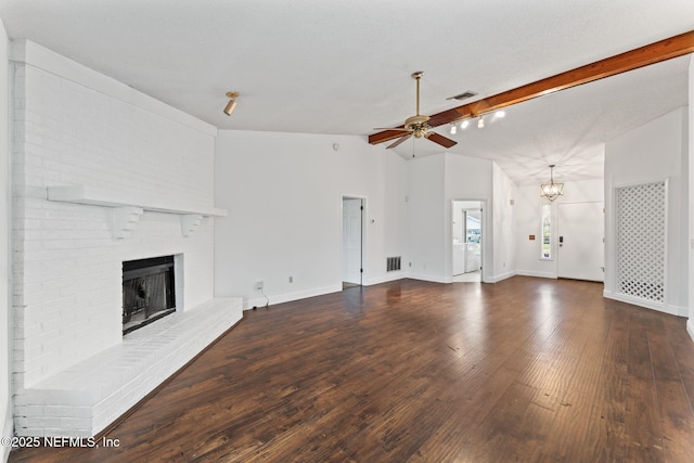 unfurnished living room featuring a fireplace, a textured ceiling, vaulted ceiling with beams, ceiling fan with notable chandelier, and dark hardwood / wood-style floors