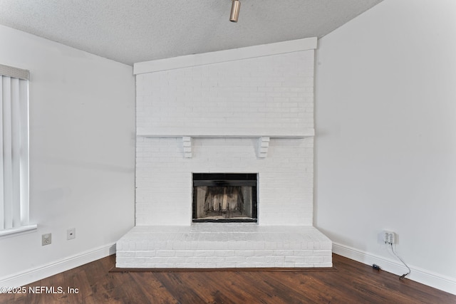 details featuring a textured ceiling, hardwood / wood-style floors, and a fireplace