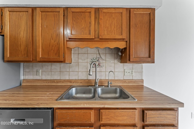 kitchen with sink, backsplash, and dishwasher