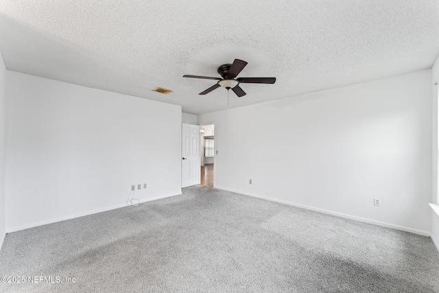 spare room featuring a textured ceiling, carpet flooring, and ceiling fan