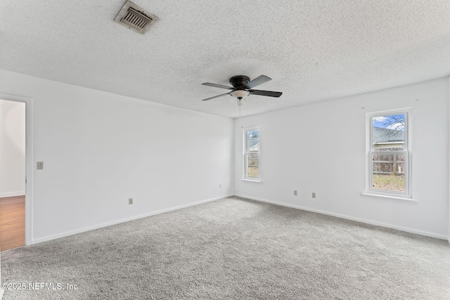 unfurnished room featuring ceiling fan, a textured ceiling, and carpet floors