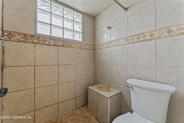 bathroom featuring toilet and walk in shower