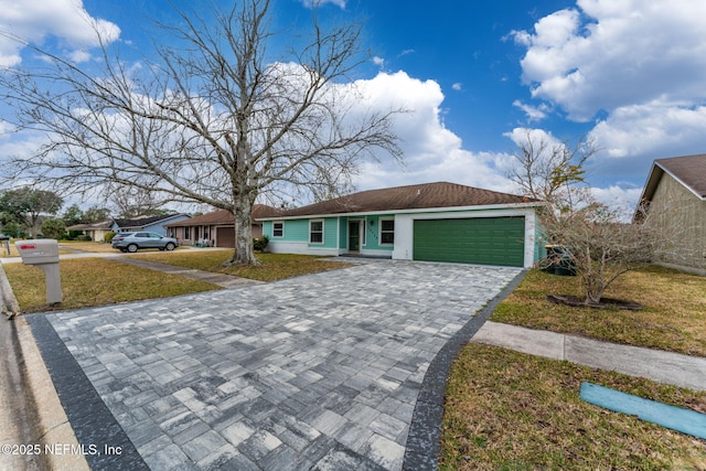 ranch-style home with a front yard and a garage