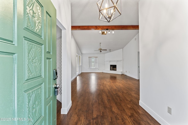 foyer with ceiling fan with notable chandelier, dark hardwood / wood-style flooring, and lofted ceiling with beams