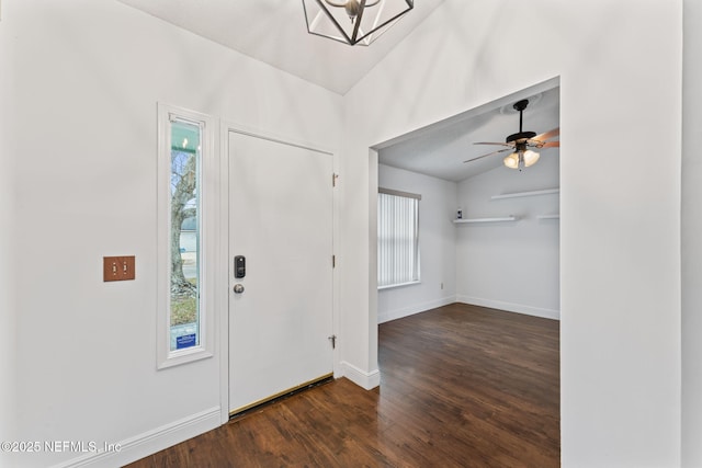 foyer entrance with dark hardwood / wood-style floors, vaulted ceiling, and ceiling fan