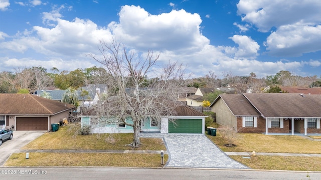 view of front of home with a garage and a front lawn