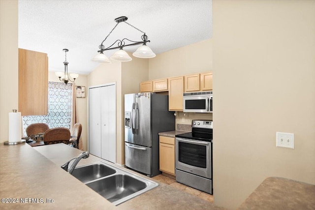 kitchen featuring sink, an inviting chandelier, hanging light fixtures, stainless steel appliances, and light brown cabinetry