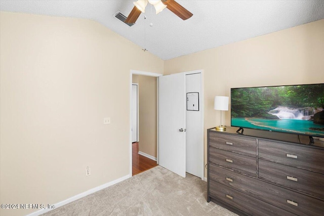 unfurnished bedroom with vaulted ceiling, light carpet, and ceiling fan