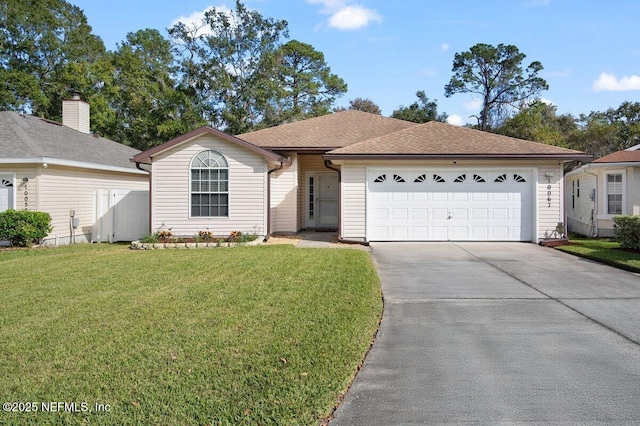 ranch-style house with a garage and a front lawn