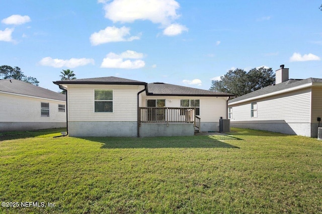 rear view of house featuring central AC unit, a yard, and a wooden deck