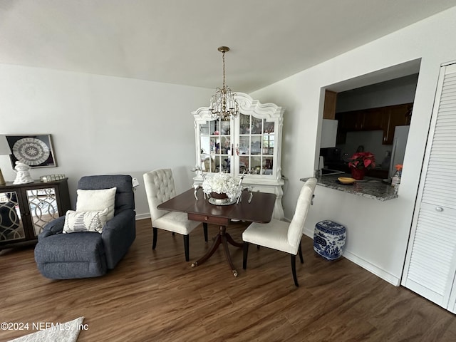 dining room featuring a wealth of natural light, dark hardwood / wood-style floors, and an inviting chandelier