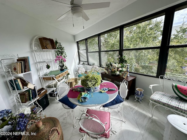 sunroom featuring ceiling fan